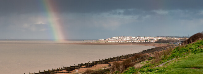 Panoramic seascape of the coastline of Whitstable in Kent united Kingdom. Rainbow on the sky after rain