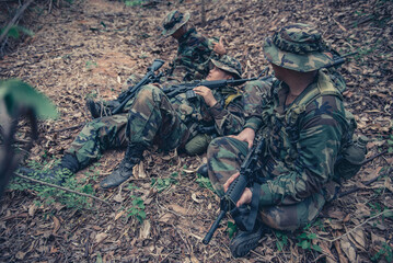 Team of army soldier with machine gun moving in the forest,Thai militia soldier in combat uniforms...