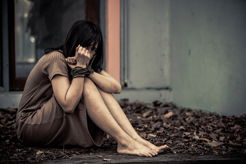 Asian hostage woman Bound with rope at night scene,The thieves kidnapped for ransom,thailand people