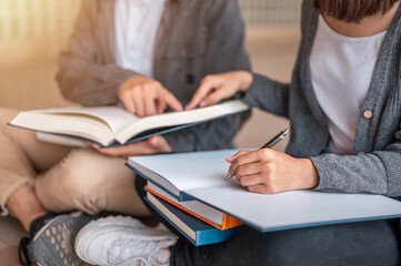 Education and Learning, Student, Campus, University, Lifestyle concept. Two students are sitting reading a books to education. Study for test preparation in University.