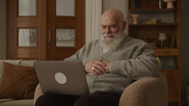 Grandfather Laugh Using Laptop at Home