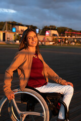Portrait of person with disability. Happy brazilian woman with a physical disability doing weekend activity in the sunset.