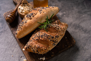 Fresh homemade bread whole wheat baguette on napkin and abstract table. Sourdough bread
