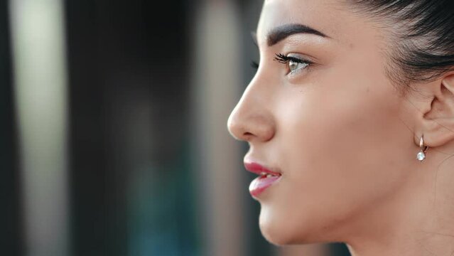 Confident strong independent beautiful young brunette woman face profile posing city outdoor closeup