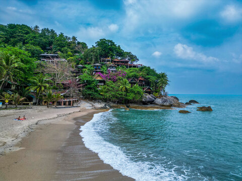 Aerial view of Than Sadet Beach with hilltop resort on Koh Phangan island, Thailand.