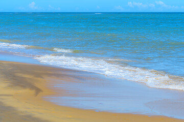 Fototapeta na wymiar The sea and sand of Espelho Beach with no people, a tropical beauty of the Brazilian coast of Bahia state. A famous tourist destination of Porto Seguro.