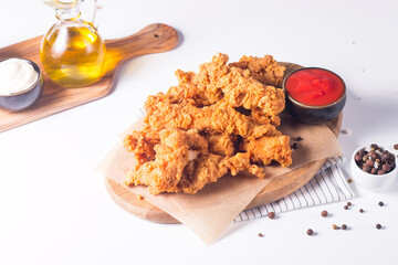 Crispy fried chicken breast strips with sauce