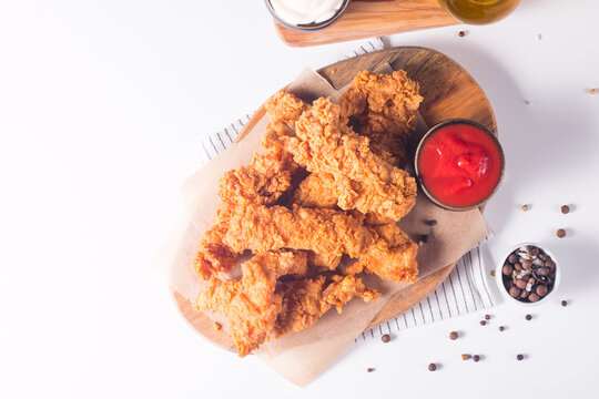 Crispy fried chicken breast strips with sauce