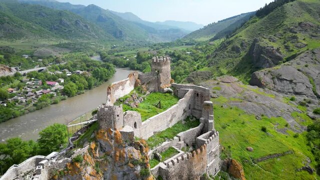 Impressive drone footage of a medieval fortress overlooking a cloudy river valley in Georgia