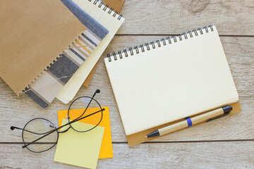 open notepad on work desk. Top view with copy space, flat lay. yellow notepad