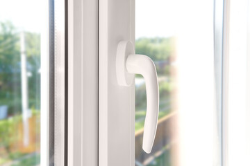 White plastic window handle. Plastic window furniture close-up.