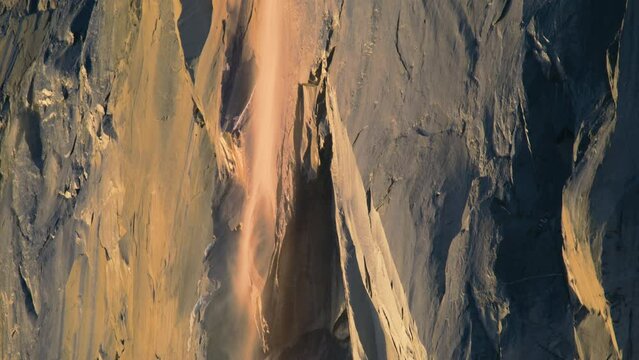 Panning shot of Horsetail fall in sunset light, Yosemite National Park, California, USA. Exited natural phenomenon of Yosemite Firefall. Winter rare event in Yosemite valley, 4k footage background