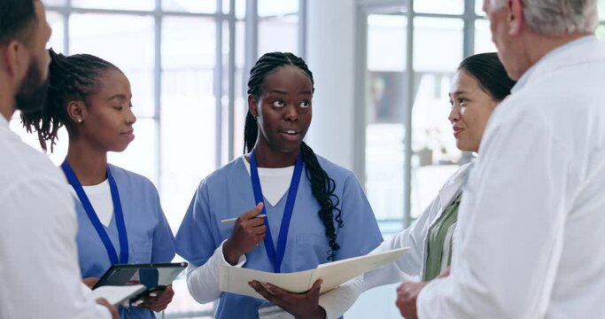 Collaboration, discussion and group of doctors in a hospital working on medical plan. Meeting, diversity and team of professional healthcare workers talking about diagnosis or consultation in clinic.