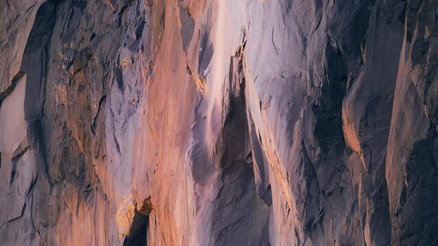 Closeup of Yosemite Firefall shimmering with sunset colors, Yosemite National Park, California, USA. Horsetail fall is geological phenomenon. Fire fall located on El Capitan rock formation, 4k footage