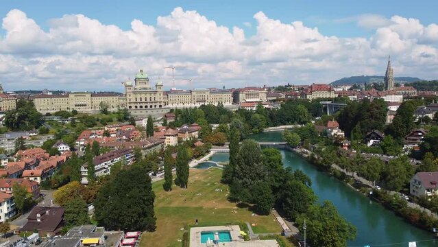 Bern, Switzerland: Aerial drone footage of the Bern historic center along the Aar river with the Parliament house, the cathedral and the Marzili baths in Switzerland capital city