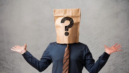 Businessman wearing paper bag on head with a question mark concept - obrazy, fototapety, plakaty