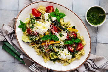 Pasta with grilled zuccini, buratta and pesto and Basil  .top veiw.selective focus