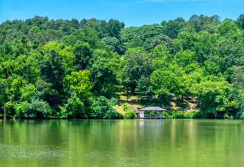 River Background Image With Boathouse at Waters Edge