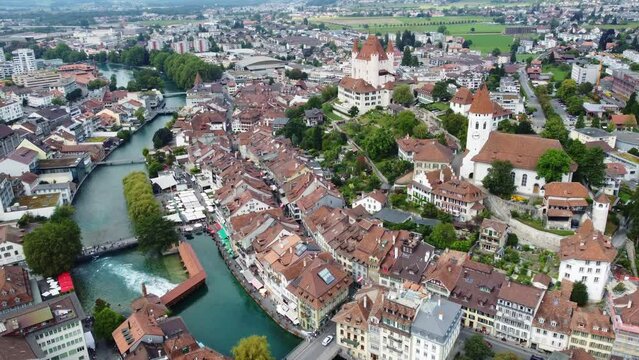 Thun, Switzerland: Aerial drone footage of the Thun medieval old town with its castle and church along the aar river in canton  Bern in the Bernese Oberland main town in Switzerland