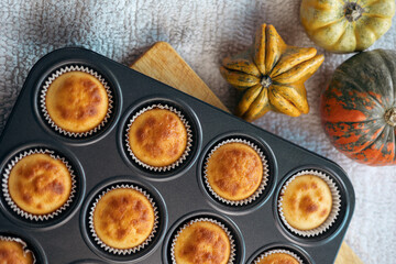  Top view and close up group homemade pumpkin muffins on wooden plank. Autumn dessert and recipes