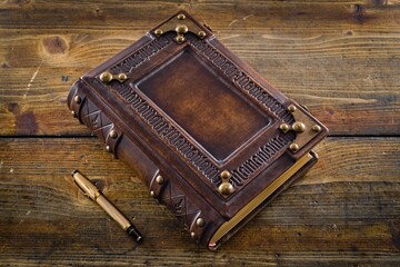 Aged leather book cover, design with embossed ambigram 