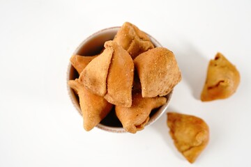 Baked mini samosa snacks with spicy nuts and beans filling - Diwali snacks isolated