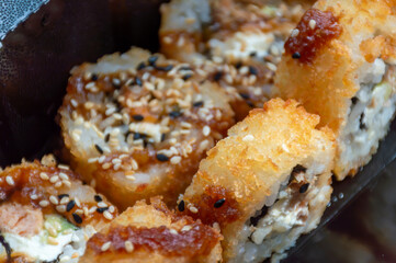 Hot tempura rolls with red fish and sweet sauce
