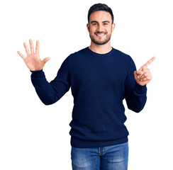 Naklejka premium Young handsome man wearing casual clothes showing and pointing up with fingers number six while smiling confident and happy.