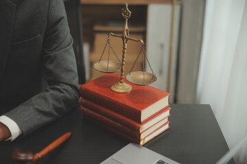 Business and lawyers discussing contract papers with brass scale on desk in office. Law, legal...