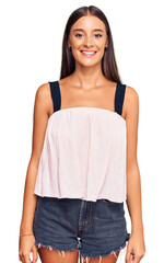 Fototapeta premium Young hispanic woman wearing casual clothes with a happy and cool smile on face. lucky person.