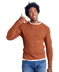 Handsome african american man with afro hair wearing casual clothes smiling doing phone gesture with hand and fingers like talking on the telephone. communicating concepts.