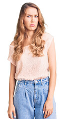 Obraz premium Young beautiful caucasian woman with blond hair wearing casual clothes skeptic and nervous, frowning upset because of problem. negative person.