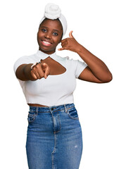 Young african woman with turban wearing hair turban over isolated background smiling doing talking...