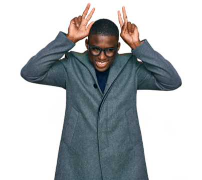 Young african american man wearing business clothes and glasses posing funny and crazy with fingers on head as bunny ears, smiling cheerful