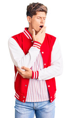 Young handsome man wearing baseball uniform bored yawning tired covering mouth with hand. restless and sleepiness.