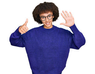 Young hispanic girl wearing casual winter sweater and glasses showing and pointing up with fingers number six while smiling confident and happy.