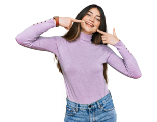Young beautiful teen girl wearing turtleneck sweater smiling cheerful showing and pointing with fingers teeth and mouth. dental health concept.