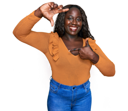 Young african woman wearing casual clothes smiling making frame with hands and fingers with happy face. creativity and photography concept.