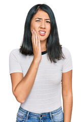 Beautiful asian young woman wearing casual white t shirt touching mouth with hand with painful expression because of toothache or dental illness on teeth. dentist