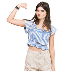 Fototapeta premium Young beautiful caucasian girl wearing casual clothes strong person showing arm muscle, confident and proud of power