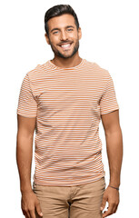 Handsome hispanic man wearing casual clothes with a happy and cool smile on face. lucky person.