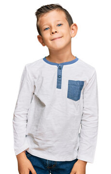 Adorable caucasian kid wearing casual clothes relaxed with serious expression on face. simple and natural looking at the camera.