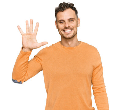 Young hispanic man wearing casual clothes showing and pointing up with fingers number five while smiling confident and happy.