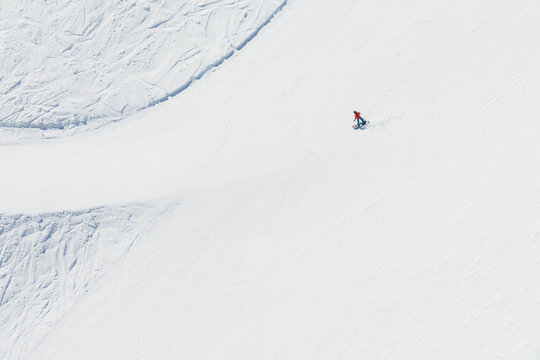 Aerial view of a snowboarder, Mount Etna, Sicily, Italy.