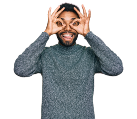Young african american man wearing casual clothes doing ok gesture like binoculars sticking tongue out, eyes looking through fingers. crazy expression.
