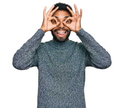 Young african american man wearing casual clothes doing ok gesture like binoculars sticking tongue out, eyes looking through fingers. crazy expression.