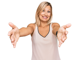 Middle age caucasian woman wearing casual clothes looking at the camera smiling with open arms for hug. cheerful expression embracing happiness.