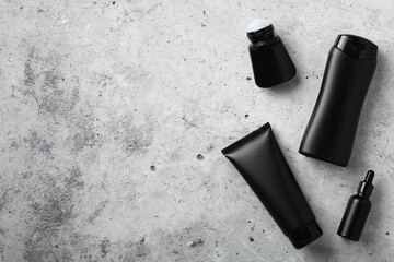 Premium men's cosmetics top view. Flat lay black shower gel tube, shampoo bottle, deodorant, serum...