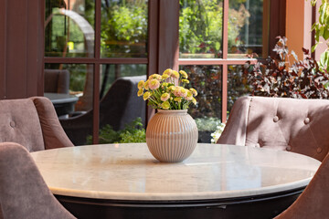 Beautiful terrace or balcony with a table, soft chairs and flowers