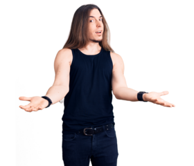 Young adult man with long hair wearing goth style with black clothes smiling cheerful offering hands giving assistance and acceptance.